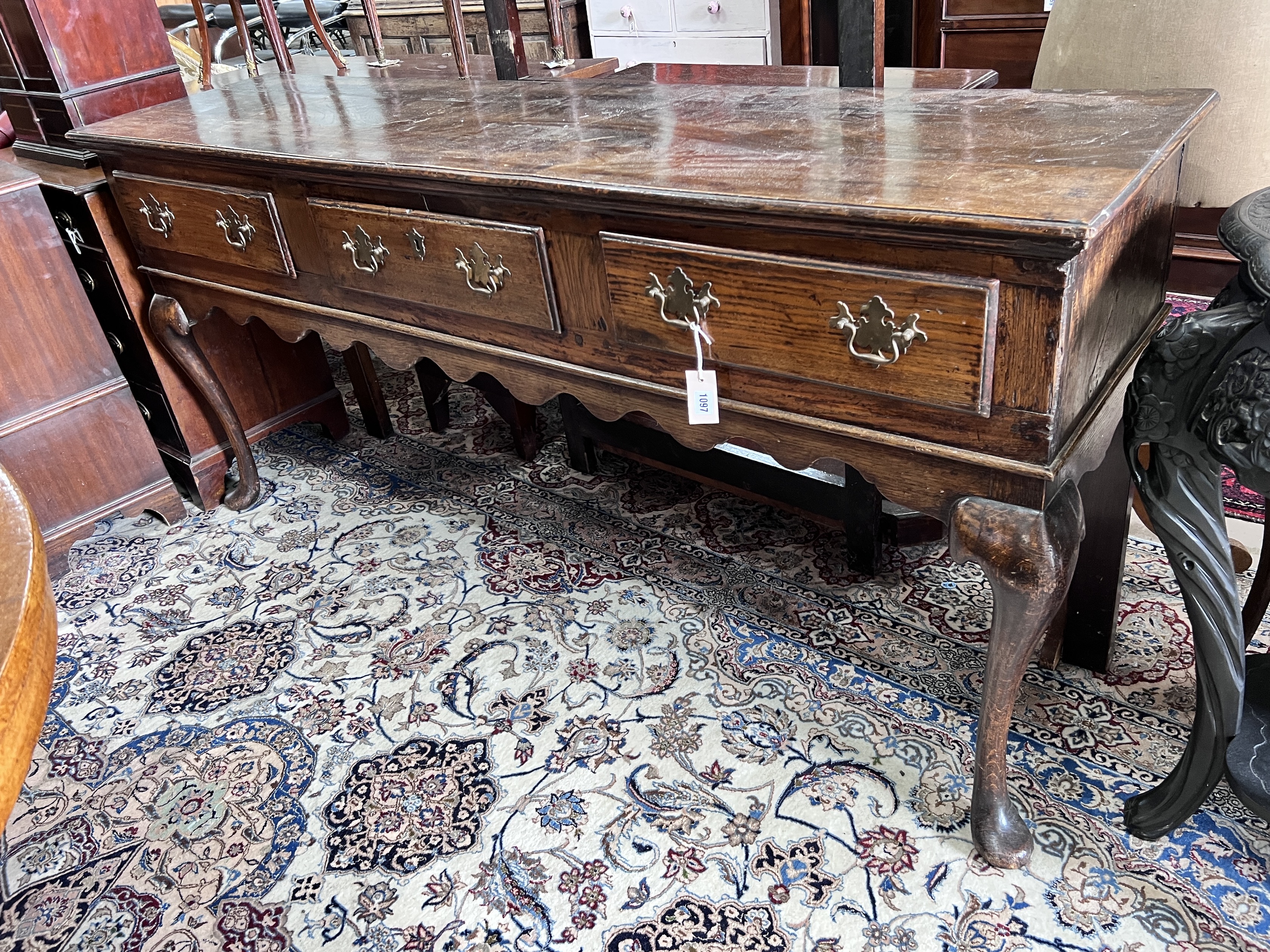 An 18th century and later oak low dresser on cabriole supports, width 178cm, depth 45cm, height 83cm